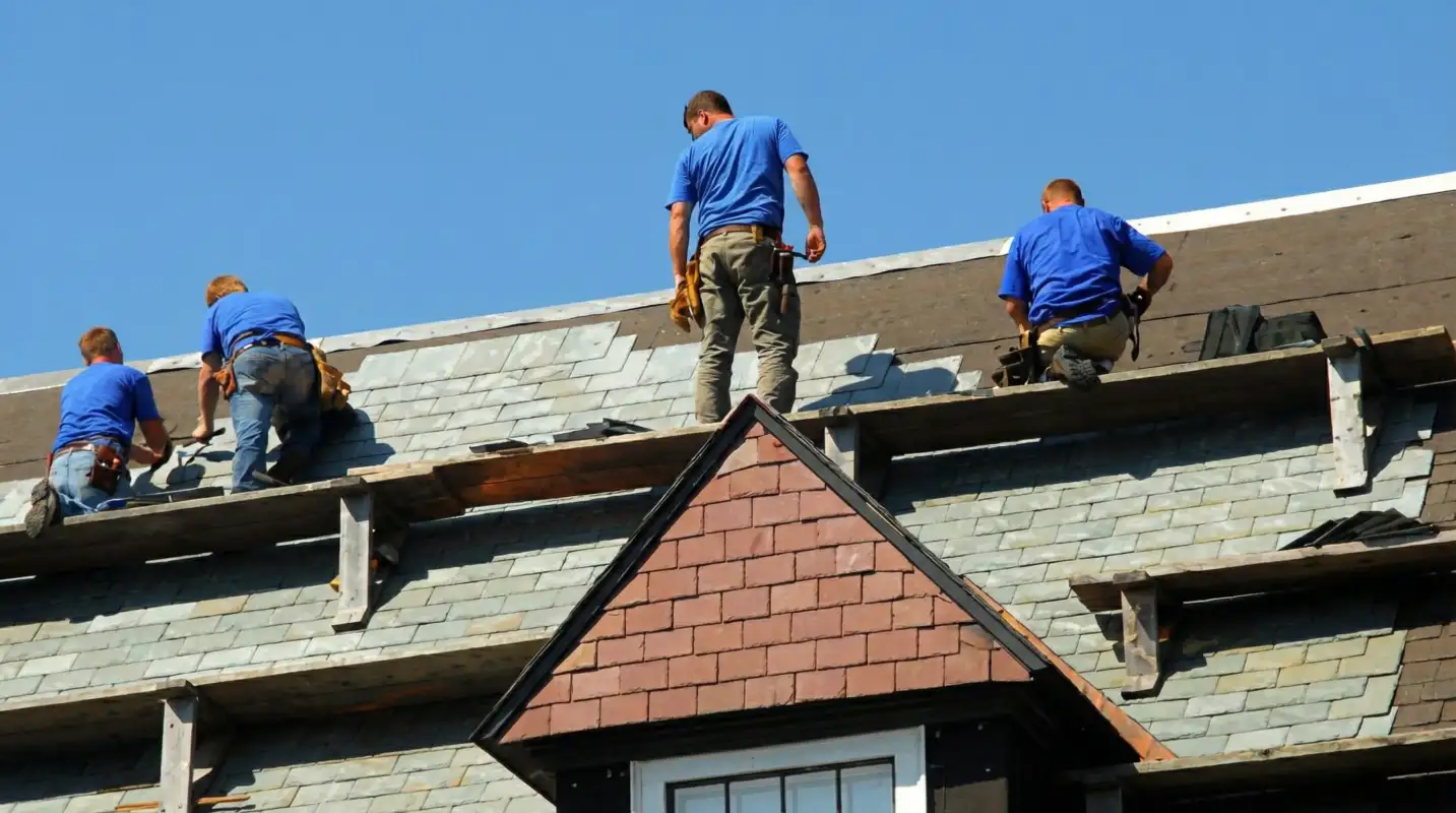 Roof replacement in progress with a team of professional contractors installing new shingles on a residential home in Seattle, WA