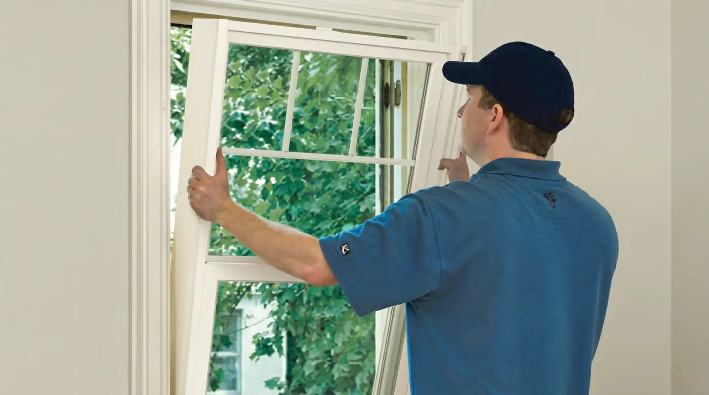 Professional contractors performing a residential window insulation and replacement service in Seattle, WA
